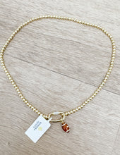 Load image into Gallery viewer, Kendra Scott Football Gold Metal Strand Necklace in White CZ